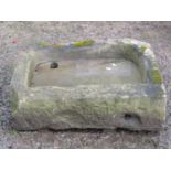 A shallow but thick walled natural stone rectangular sink/trough with rounded front corners 72 cm