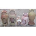 four small Mediterranean terracotta candle or tea light holders in the form of jars with moulded