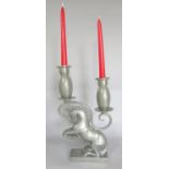 A pewter kneeling horse candelabra with two scrolled sconces, 34cm high