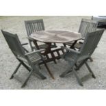 A weathered folding hardwood garden table with octagonal slatted panelled top, together with a set