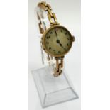 A vintage ladies 9ct gold wristwatch, the strap marked 9ct, currently running