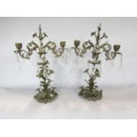 A pair of Rococo style bronze effect candelabra decorated with glass facetted drops 44cm high.