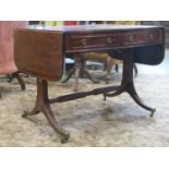A Georgian mahogany sofa table of usual form with two real and two dummy drawers, raised on a
