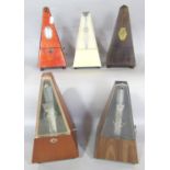 Five metronomes of varying age and make.