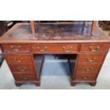 Georgian style pedestal writing desk of nine drawers with inset leather top on bracket supports,