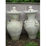 Two similar Mediterranean terracotta baluster shaped vases and covers with loose ring handles and