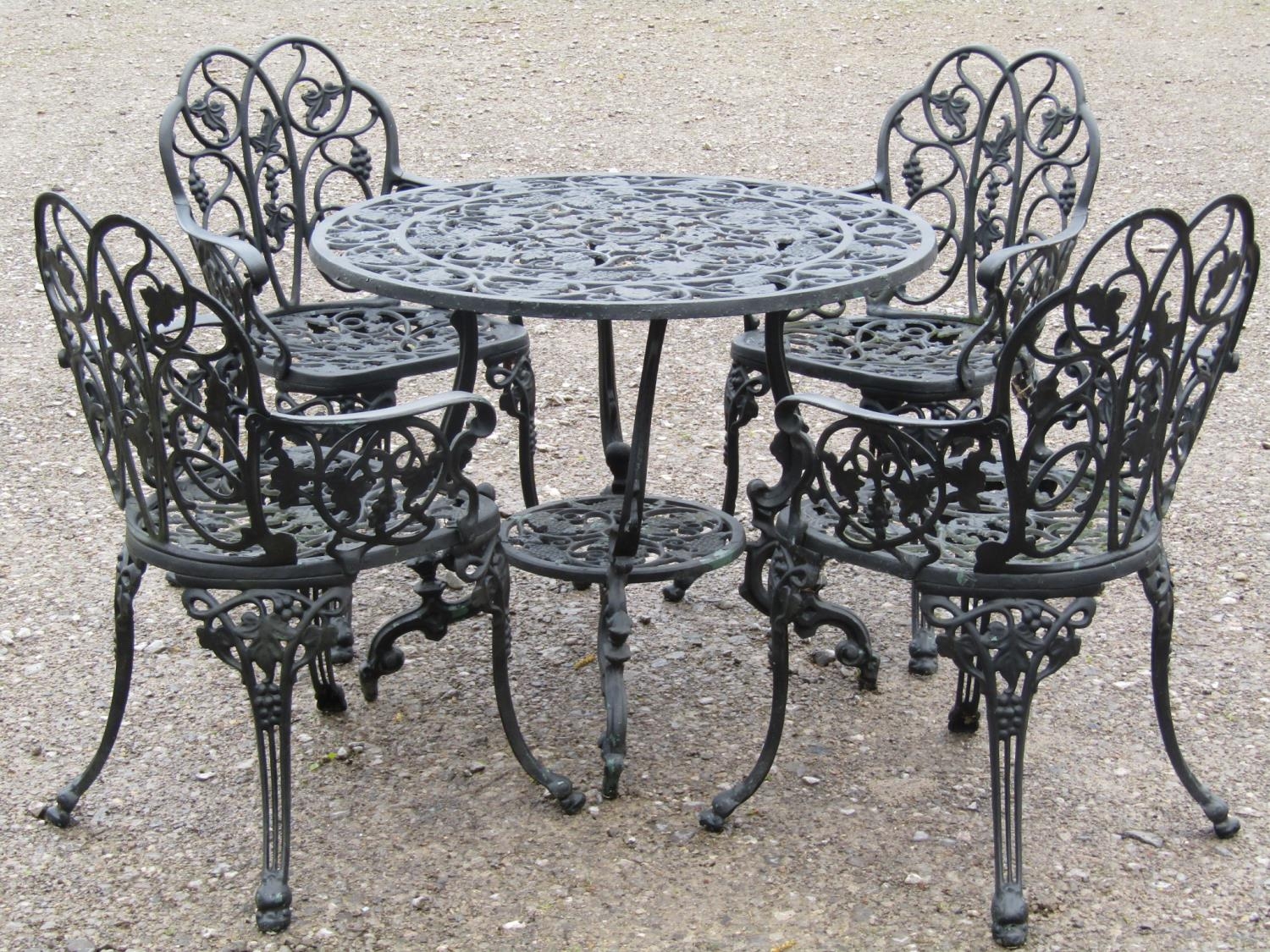 A good quality heavy gauge cast alloy garden terrace suite comprising circular top table, 89 cm in