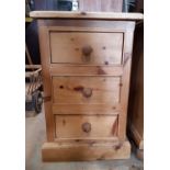 A small stripped pine chest of three drawers