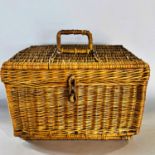 A vintage cane picnic basket with fall down front revealing a fitted interior for a burner, metal