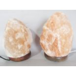 A pair of Himalayan rock salt crystal lamps, both 22cm tall approx.