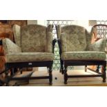 A pair of colonial style wing chairs with turned spindle work frames and upholstered finish