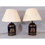 A pair of black tole ware tea canisters with painted coat of arms, converted to table lamps, each