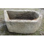 An unusual weathered carved natural stone rectangular D end and canted stone trough with circular