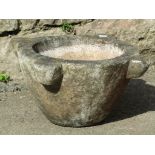 A weathered carved marble mortar 45 cm wide at widest part x 22 cm high