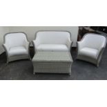 A Bramble Crest four piece garden suite comprising two seat sofa, pair of matching armchairs and low