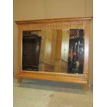An old charm light oak framed overmantle mirror with rectangular bevelled edge plate and carved