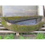 A weathered shallow but thick walled D shaped sandstone trough 126 cm wide x 58 cm deep x 18 cm high