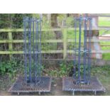 A pair of painted heavy gauge galvanised steel cylindrical strapwork tree guards and square stands