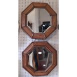 A pair of oak framed octagonal wall mirrors with bevelled edge plates