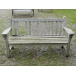A vintage heavy gauge weathered teak garden bench with slatted seat and back, 162 cm wide together