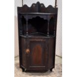 19th century poker work hanging corner cupboard with floral detail, partially enclosed by a panelled