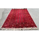 A large Turkoman carpet with a central panel with three rows of elephant foot guls on a