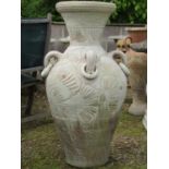 A large Mediterranean terracotta baluster shaped vase with moulded loop and ring handles and