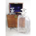 A 19th century mahogany travel drinks box with an inset brass handle, containing two decanters
