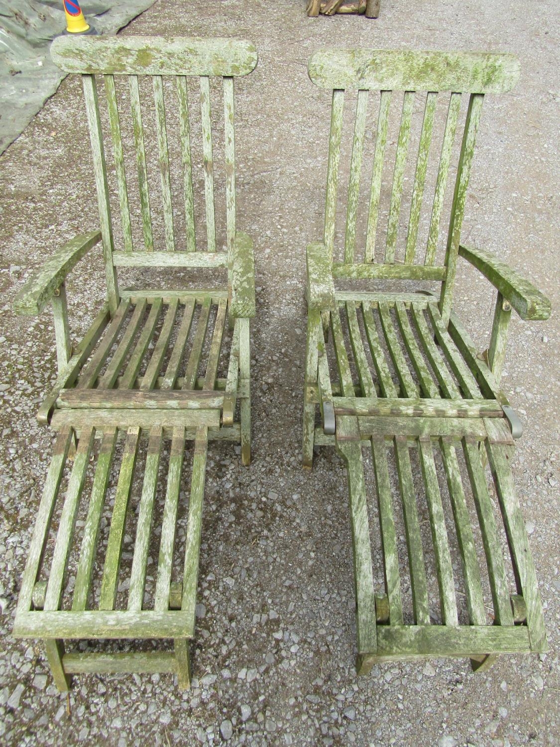 A pair of well weathered teak folding garden steamer type lounge chairs with slatted seats, backs - Image 4 of 4