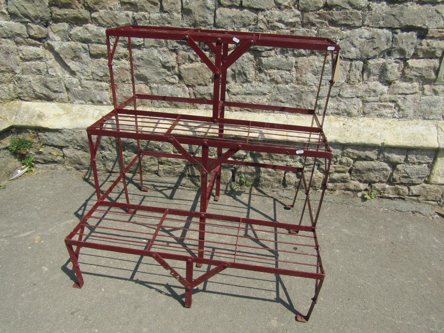 A painted strapwork plant stand on three stepped tiers 91 cm wide x 75 cm deep x 90 cm high