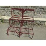 A painted strapwork plant stand on three stepped tiers 91 cm wide x 75 cm deep x 90 cm high