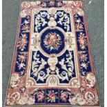 An 18th century style tapestry wall hanging with a lime green floral design on fawn ground, and