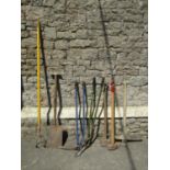A small collection of vintage and later long handled mainly garden related tools