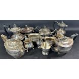 A mixed selection of silver plated teapots, coffee pots of various styles together with some