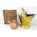 A 19th century brass coal helmet with a decorative floral embossed cover, a copper hammer finished