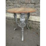 A painted cast alloy pub table with Britannia mask detail with adapted and probably associated
