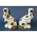 A pair of 19th century Staffordshire spaniels with gilt lustre patches, 25cm tall