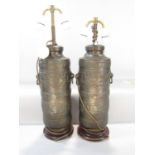 A pair of bronze table lamps in the form Tibetan Prayer Wheels, with loop handles and two adjustable