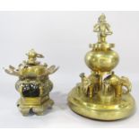 An Indian brass temple fitting with a bowl with cover raised on three elephants each with a