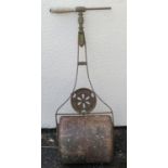 A small antique cast iron garden roller with pierced medallion, 36 cm wide (full width) (af)