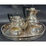 A four piece silver plated tea service, an oval silver plated tray with filigree detail to the