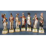 A collection of fourteen Napoleonic figures in military costume, 30cm tall approx