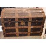 A vintage timber lathe bound domed top travelling trunk with simulated crocodile finish, (af)