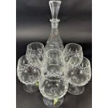 An Edwardian style cut glass decanter with six matching brandy goblets, and salt and pepper pots