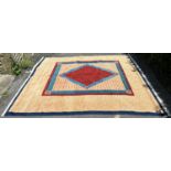 A modern (new) Turkish wool carpet with a red diamond centre with a turquoise and red border and