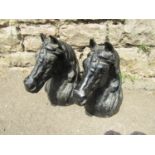 A pair of small good quality heavy gauge cast iron horses head finials, 27 cm high