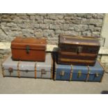 A vintage wooden lathe bound domed top travelling trunk together with a tin trunk and two wooden and