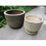 Two weathered circular contemporary planters of varying design, the larger ribbed example 48 cm