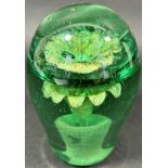A Victorian green glass dump, with a silver potted plant internal decoration, 11cm high.