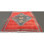 A modern Kazak design carpet in wool with a central stepped medallion decorated with flowers on a